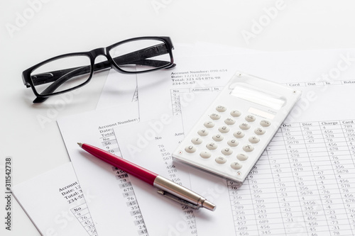 Taxes calculation concept. Financial documents, calculator, glasses on white background