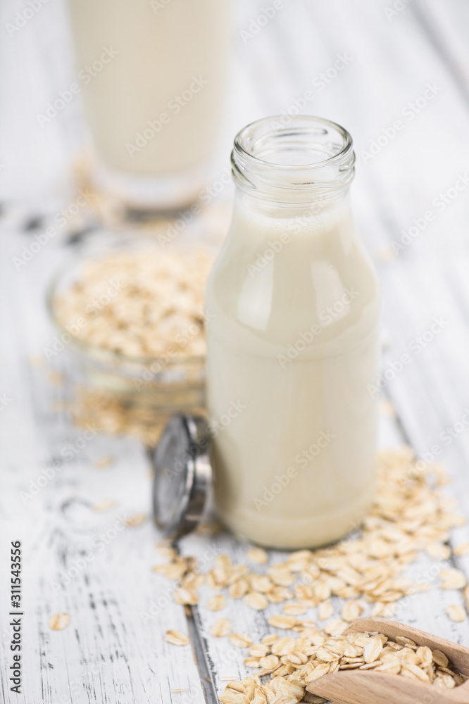 Old wooden table with fresh Oat Milk (close-up shot; selective focus) Old wooden table with fresh Oat Milk (close-up shot; selective focus)