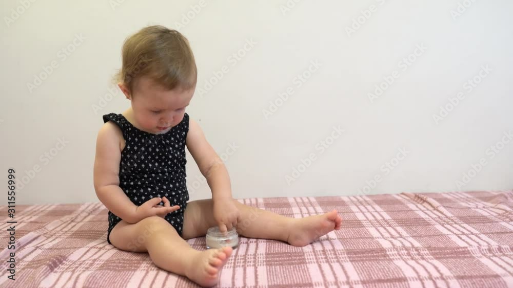 baby likes white cream on his cheeks , child body care baby likes white cream on his cheeks , child body care