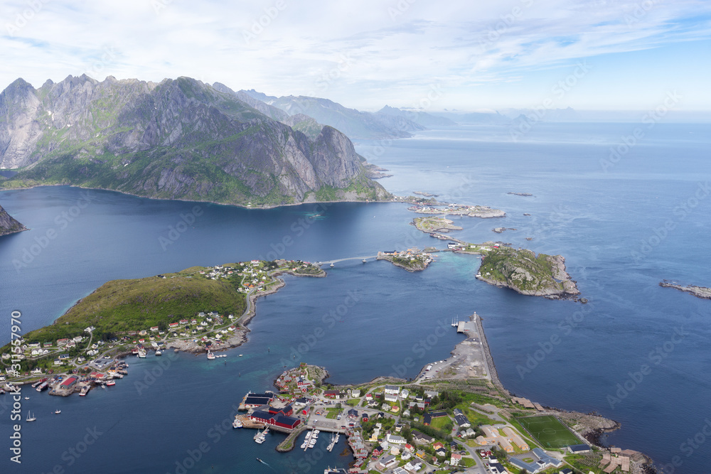 Scenery view with dramatic mountains and peaks, open sea and sheltered bays, beaches and untouched lands. Aerial panorama of fishing town Reine and surrounding fjords on Lofoten islands in Norway.