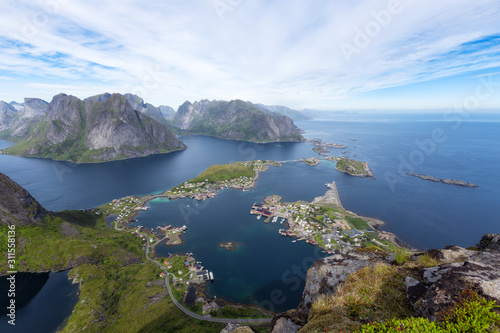 Scenery view with dramatic mountains and peaks, open sea and sheltered bays, beaches and untouched lands. Aerial panorama of fishing town Reine and surrounding fjords on Lofoten islands in Norway.