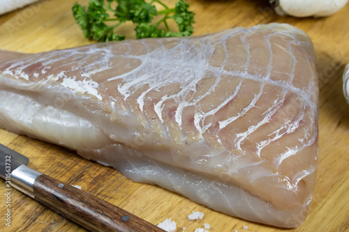 Fotomural raw saithe fillet on a cutting board