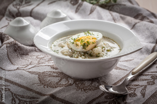 Sorrel soup with egg in white bowl. photo