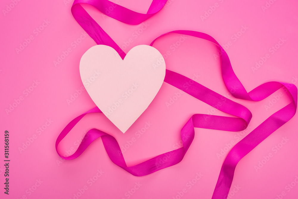 top view of empty paper heart with ribbon isolated on pink
