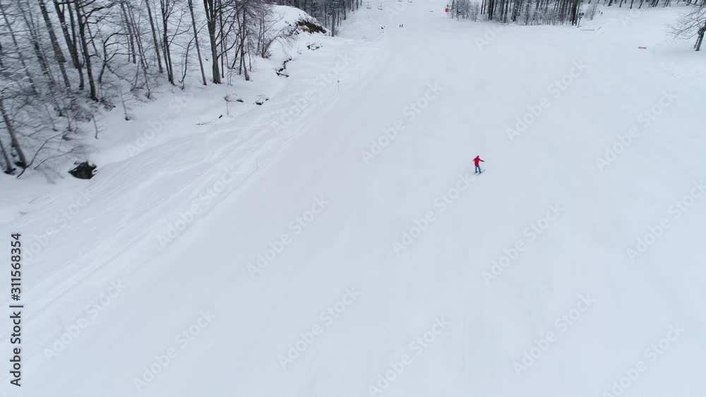 Aerial view of of skier rides from the mountain at Ski Resort Aerial view of of skier rides from the mountain at Ski Resort