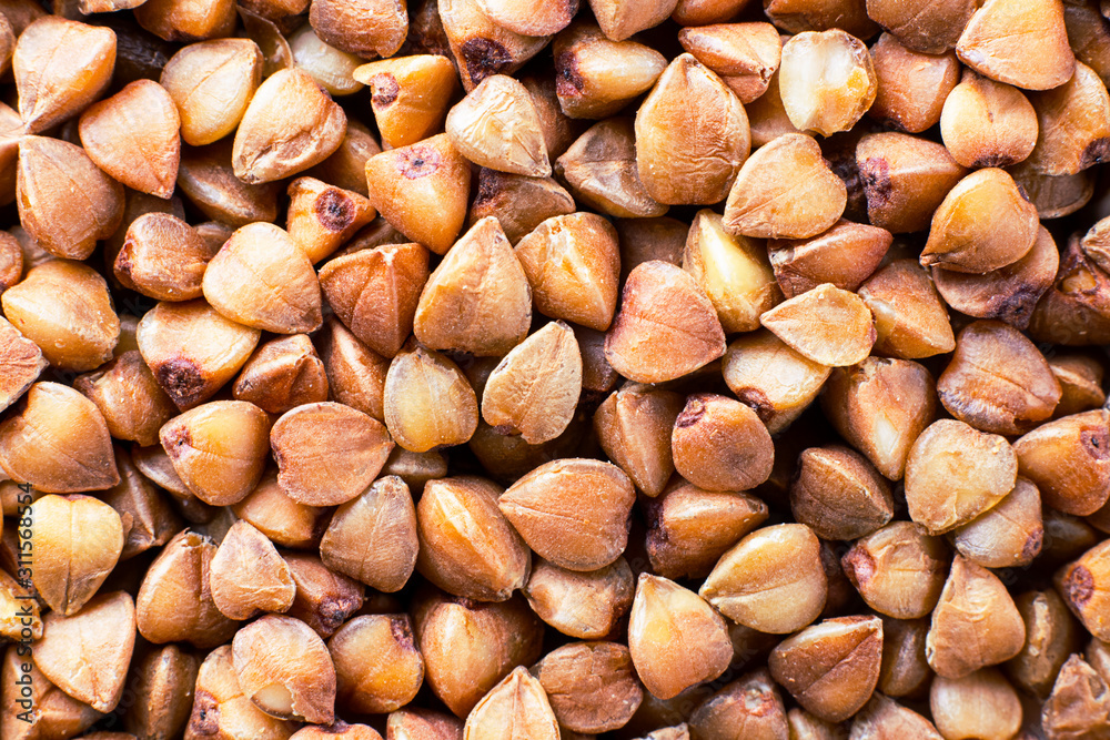 Buckwheat groats background. Close up. Macro. Healthy food, diet, veg, natural product. Horizontal Buckwheat groats background. Close up. Macro. Healthy food, diet, veg, natural product. Horizontal