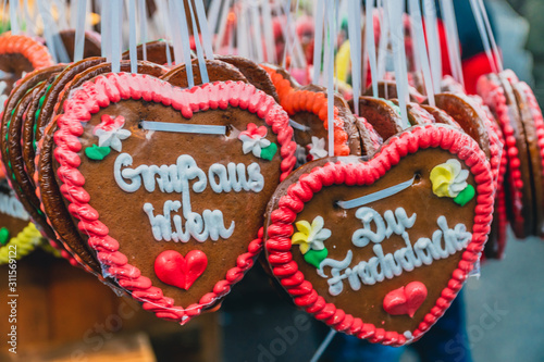 Photography Traditional decorated Christmas gingerbread hearts on the Christmas market in Vienna