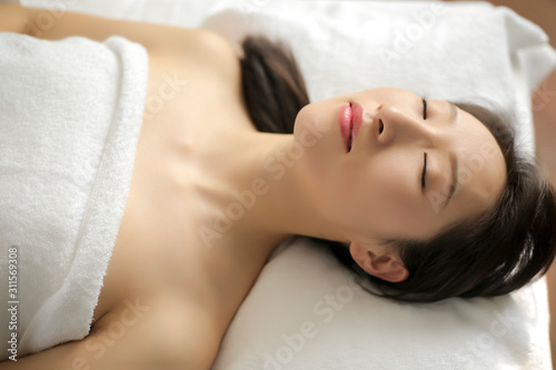 Asian female enjoying a nap with eyes closed