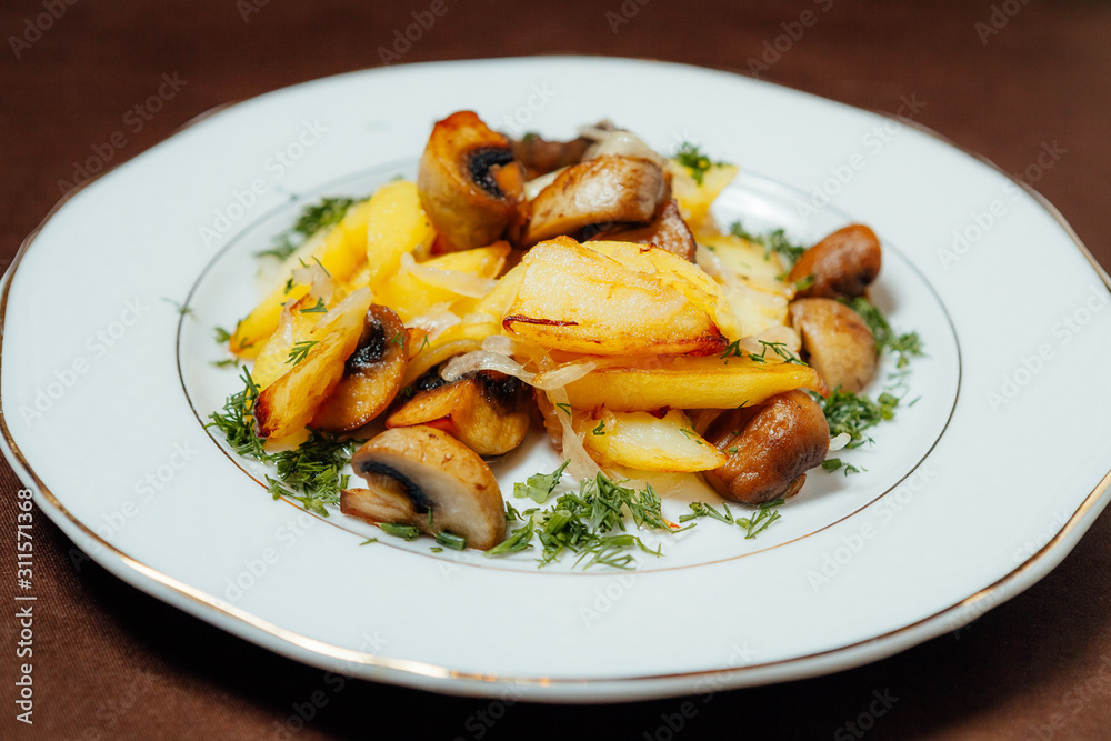 Fried potatoes with mushrooms and onions