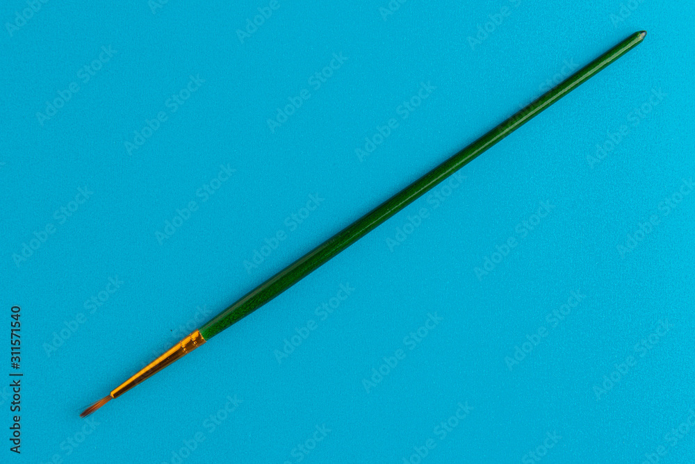 Paintbrush Isolated On Blue Background Paintbrush Isolated On Blue Background