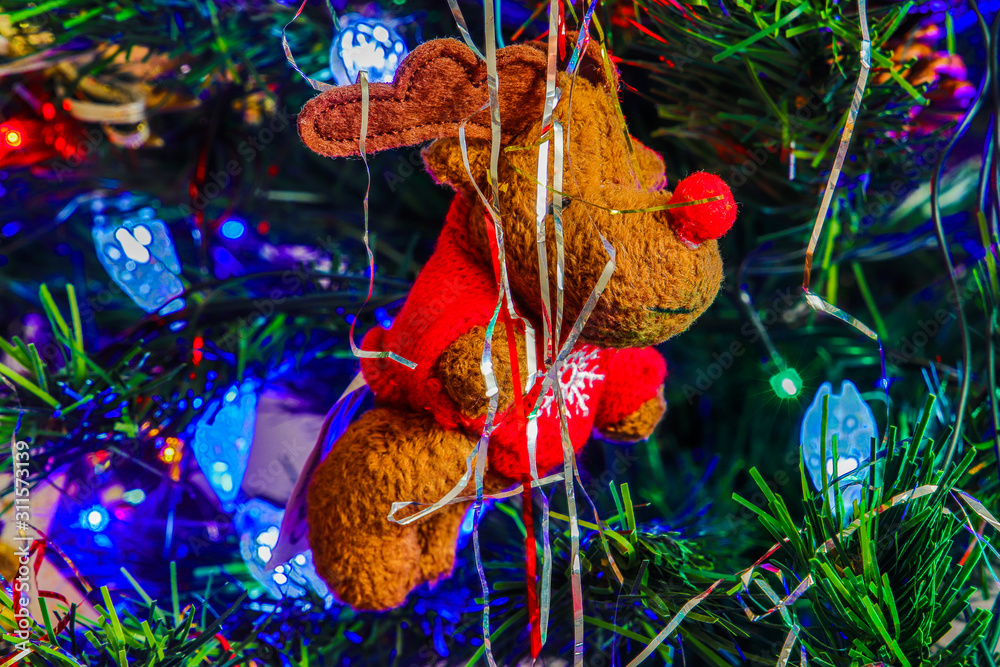 Soft reindeer toy hanging from Xmas Tree.