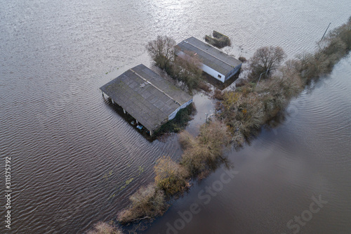 Aerial view of a farm between fields flooded by storms in December 2019 in the province of Ourense, Galicia. Spain.