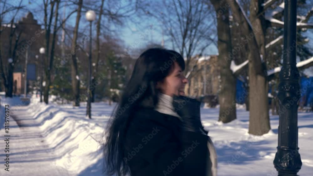 Very Happy Beautiful Girl Jumps Hands Up Feeling Awesome Glad Emotion In Snow Covered Park. Winter City Life. Bright Sunny Day. Slow Motion 30 fps 0.5 of real time speed 60 fps Very Happy Beautiful Girl Jumps Hands Up Feeling Awesome Glad Emotion In Snow Covered Park. Winter City Life. Bright Sunny Day. Slow Motion 30 fps 0.5 of real time speed 60 fps