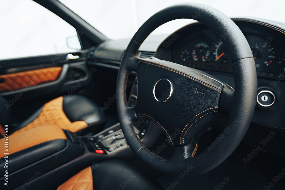 Sports car interior with black and orange leather