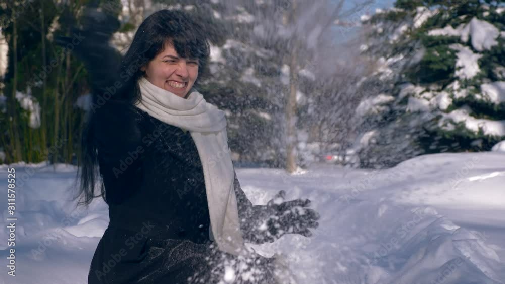 Happy Pretty Girl Throws Snow In Air. Snow Covered Park. Winter City Life. Slow Motion 60 fps 4K Happy Pretty Girl Throws Snow In Air. Snow Covered Park. Winter City Life. Slow Motion 60 fps 4K