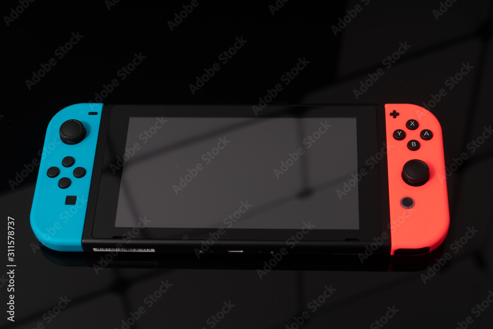 Nintendo Switch video game console developed by Nintendo, released on March  3, 2017 on a black background. Germany, Berlin - June 30, 2019: Nintendo  Switch Joy-con controller on a white background Stock Photo | Adobe Stock