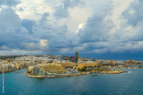 Aerial view of Saint Julian's city and Portomaso tower. Winter, sea, seafront, cloudy sky. Malta island