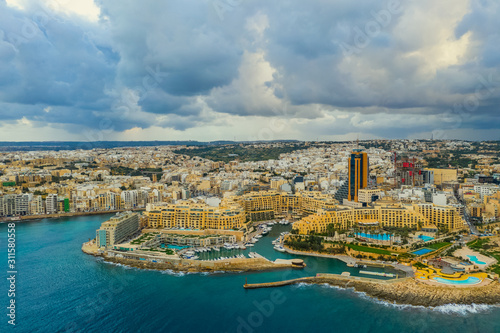 Aerial landscape view of St. Julian's city. Winter, storm clouds, Portomaso tower. Malta