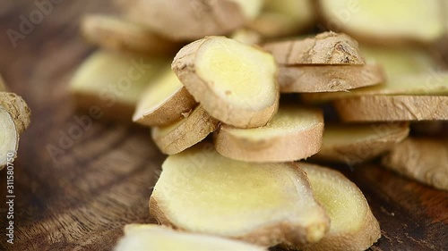 Rotating wooden plate with fresh Ginger as seamless loopable 4K footage