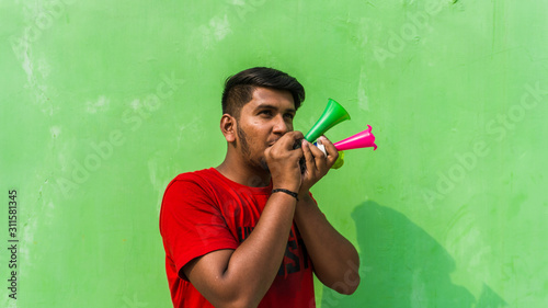 Young man with firki and pipuda for Makar Sankranti festival of India. Makar Sankranti is kite festival of India. It is also known as uttarayan photo