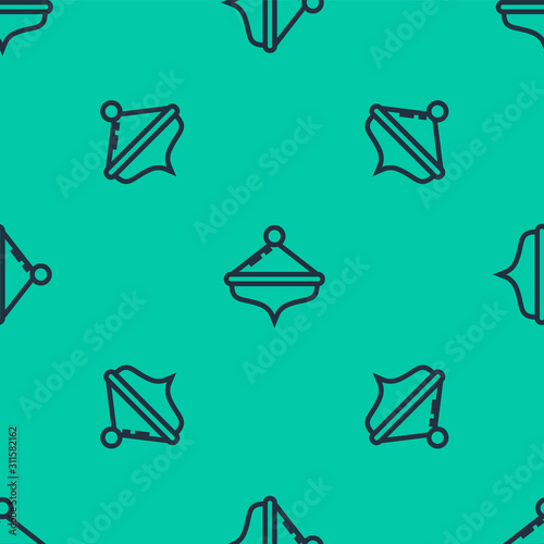 Blue line Hanukkah dreidel icon isolated seamless pattern on green background. Vector Illustration photo