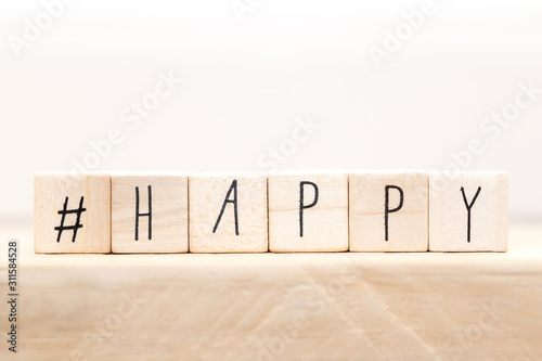Wooden cubes with a Hashtag and the word Happy, smile and heart, social media concept background