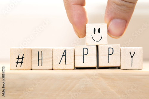 Wooden cubes with a Hashtag and the word Happy, smile and heart, social media concept background