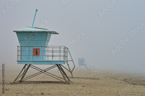 Lifeguards towers on the beach during foggy weather in Santa Cruz, CA