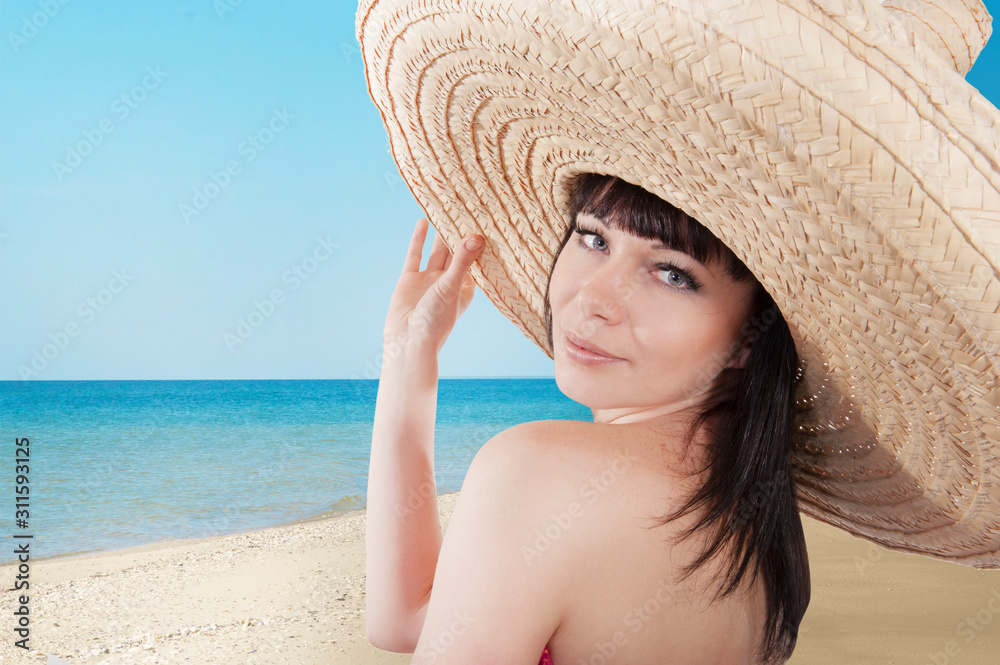 Girl in mexican hat on the seashore