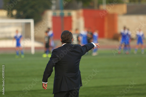 Football coach controlling the game photo