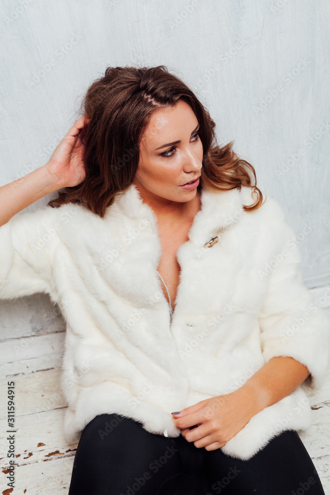 portrait of a beautiful fashionable woman with hair curls in a white fur coat in winter portrait of a beautiful fashionable woman with hair curls in a white fur coat in winter