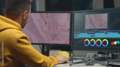 Wallpaper Mural Freelance videographer colorist editing footage using professional software, monitor and montage console. Torontodigital.ca