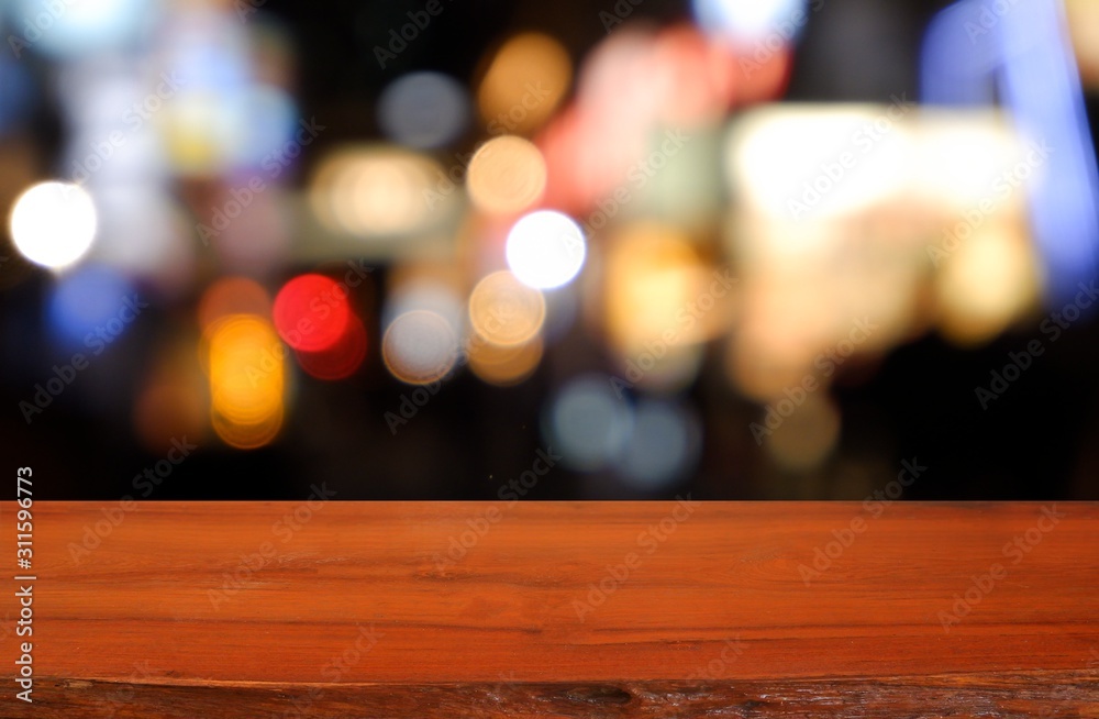 Empty dark wooden table in front of abstract blurred background of cafe coffee shop city night light. can be used for display or montage your products - Image