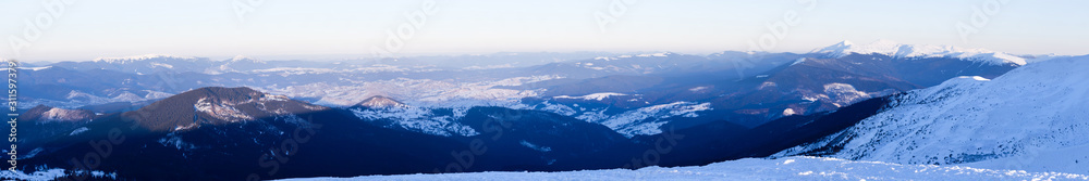 Panoramic view of winter mountain peaks covered with snow