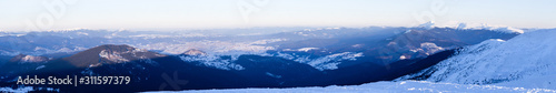 Panoramic view of winter mountain peaks covered with snow