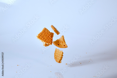 biscuits falling on a bright blue background