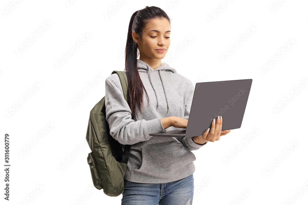 Girl with a backpack typing on a laptop Girl with a backpack typing on a laptop