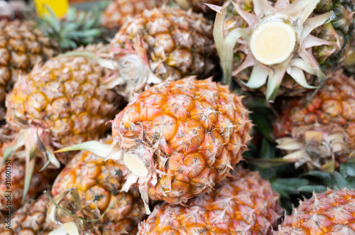 group of pineapple fruit at traditional marketplace