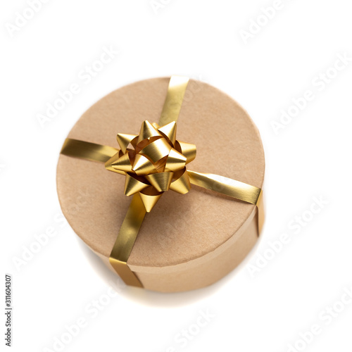 Craft box with golden ribbon isolated on white background. Holiday decoration and gifts. wide angel view with dhadow. Valentine present.