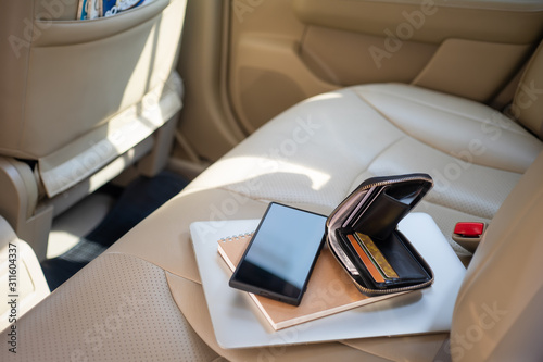 Fotografie View from outside of the car at valuables wallet, purse laptop or computer noteb