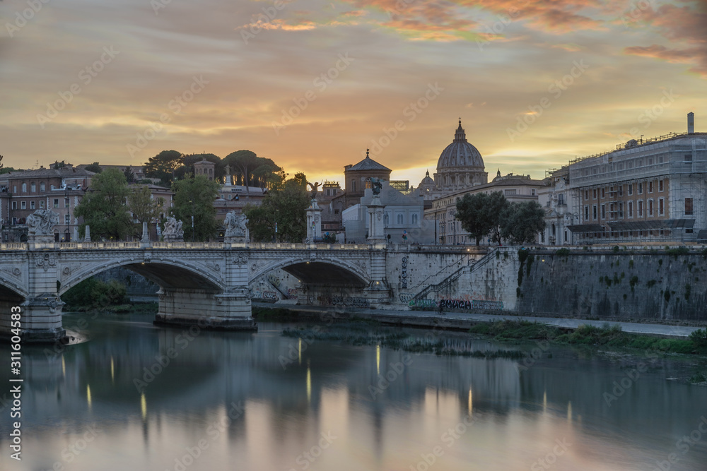 Bridge and Tiber River with view of Saint Peters Church in Rome