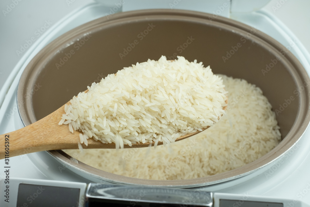 Close up Jasmine rice cooking in electric rice cooker Close up Jasmine rice cooking in electric rice cooker