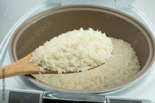 Close up Jasmine rice cooking in electric rice cooker photo