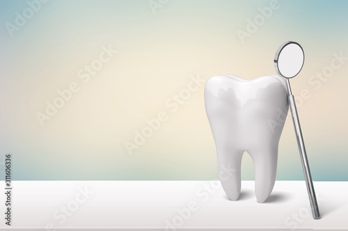 Human s white tooth with dentist mirror
