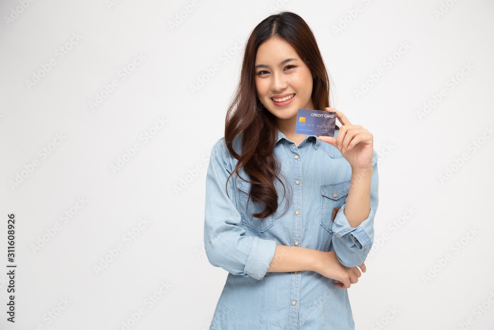 Young beautiful Asian woman smiling, showing, presenting credit card for making payment or paying online business, Pay a merchant or as a cash advance for goods, Cardholder or A person who owns a card Young beautiful Asian woman smiling, showing, presenting credit card for making payment or paying online business, Pay a merchant or as a cash advance for goods, Cardholder or A person who owns a card