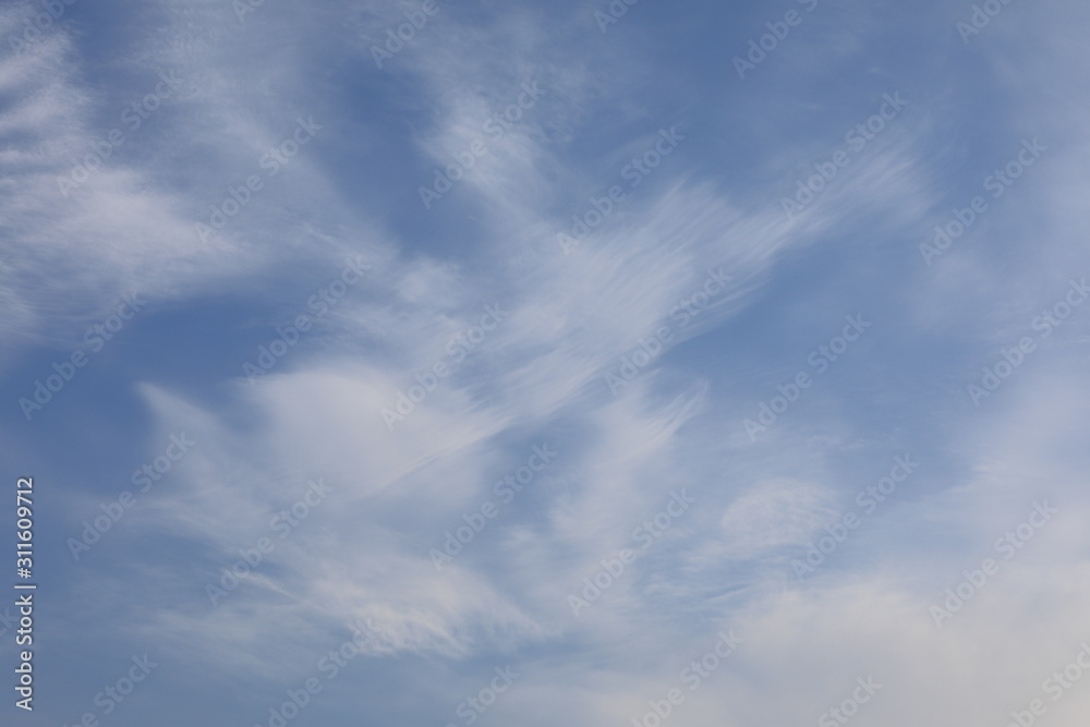 winter white clouds on blue sky background