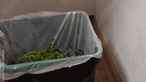 Housewife throws rotten vegetables in the trash. Reducing food loss and waste. Food waste or loss is food that is wasted or lost uneaten