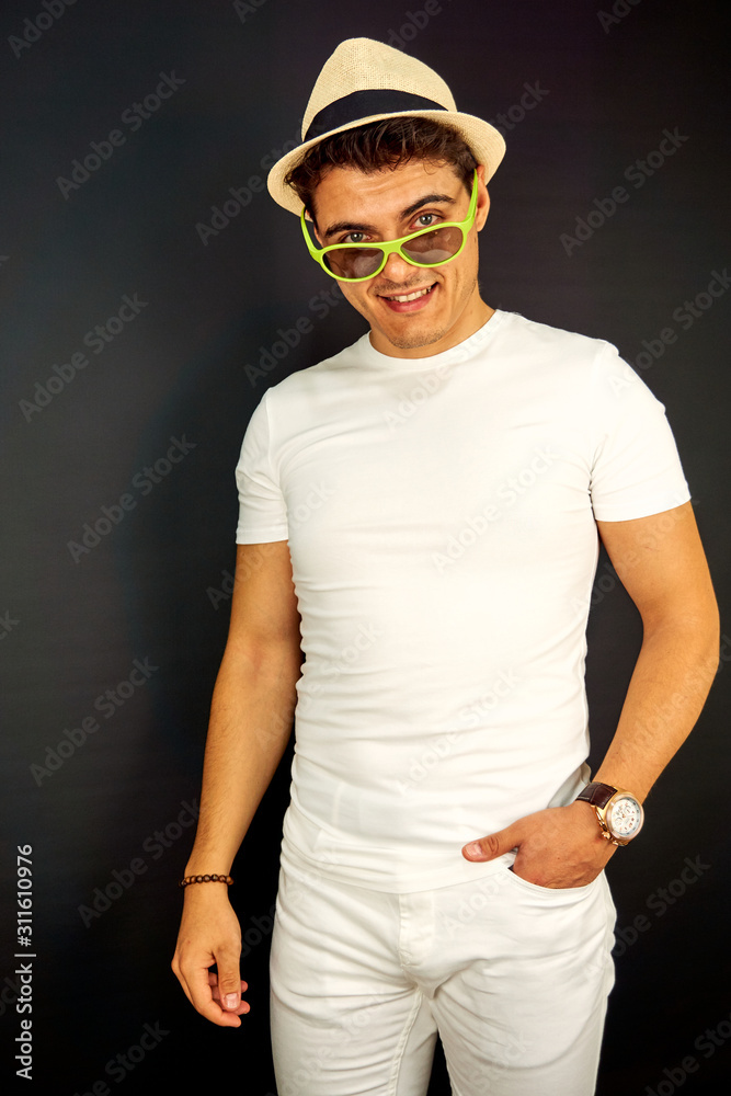 Naklejka premium Young handsome model with eyeglasses and hat