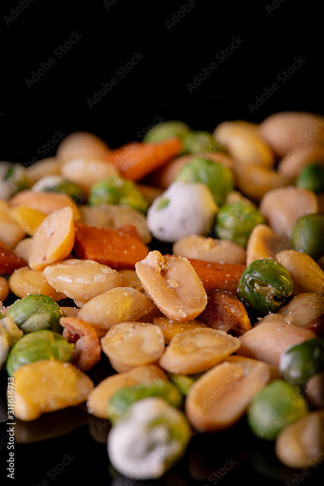 A pile of mixed nuts, healthy snack, on black background A pile of mixed nuts, healthy snack, on black background