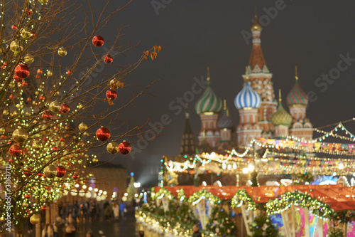 Bright illuminated Red Square, facade of the Saint Basil's Cathedral in Moscow. Lighting and decoration of the Red Square during winter night.